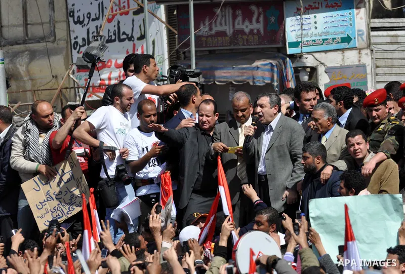 Egyptian Prime Minister designate Essam Sharaf, holding the microphone, speaks to demonstrators at Tahrir Square in Cairo, Egypt, Friday, March 4, 2011. Egypt's new prime minister designate has vowed before thousands of...