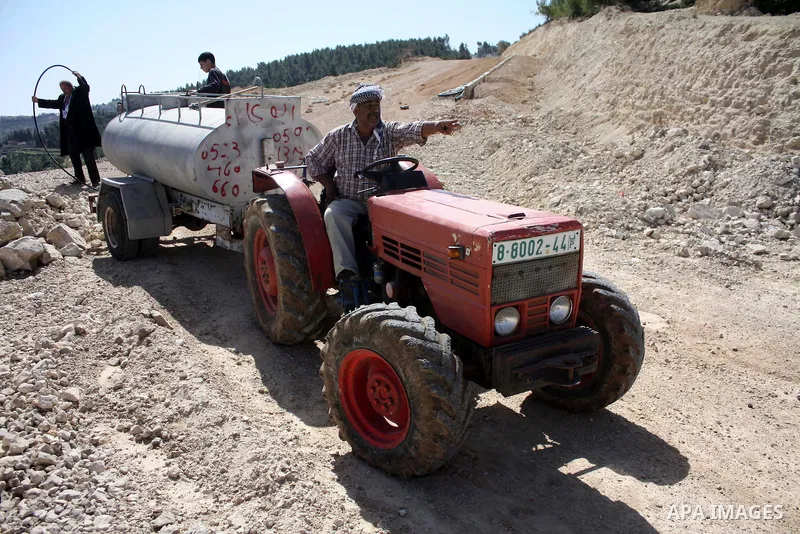Palestinian take part to plant olive trees during a protest against Israel's controversial separation barrier in the West Bank village of Al Waljeh, near the biblical town of Bethlehem on March 04, 2011.Israel says the n...