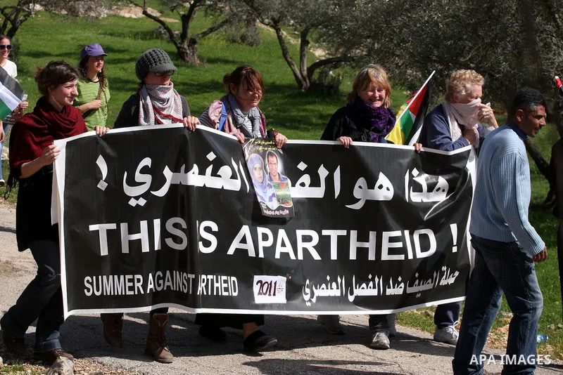 Palestinians and foreigners take part in a protest against Israel's controversial separation barrier in the village of Bilin, near the West Bank city of Ramallah, in the Israeli occupied West Bank, on March 4, 2011.photo...