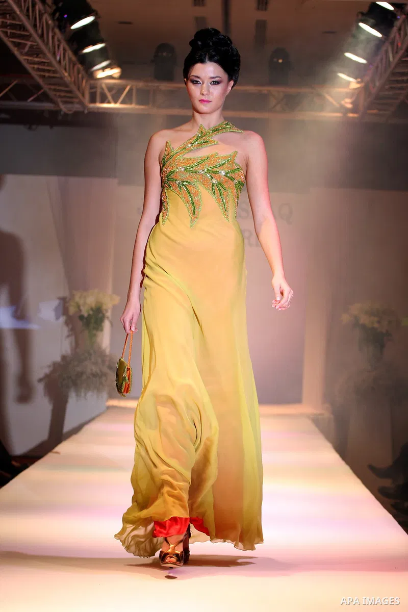 A model takes the catwalk wearing a design by Palestinian fashion designer Jamal Taslaq during a fashion show sponsored by the Italian Consulate-General and the Palestinian Ministry of Culture as part of a wedding fair i...