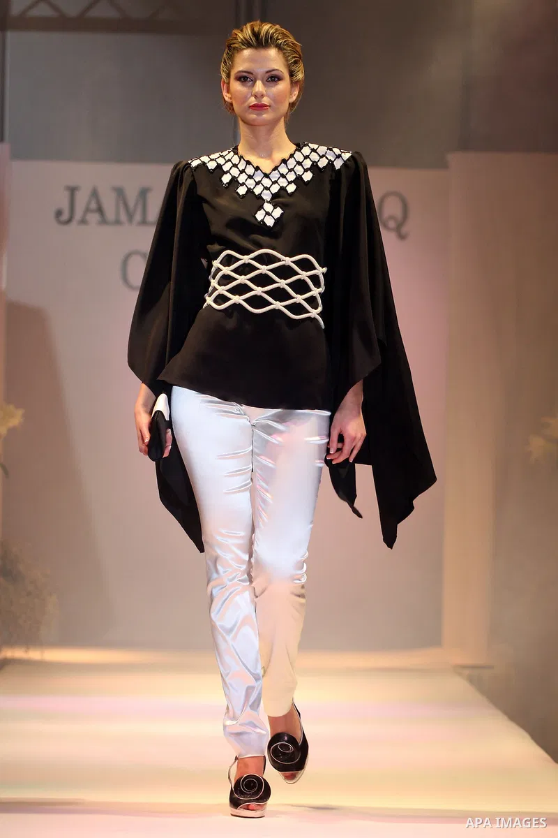 A model takes the catwalk wearing a design by Palestinian fashion designer Jamal Taslaq during a fashion show sponsored by the Italian Consulate-General and the Palestinian Ministry of Culture as part of a wedding fair i...