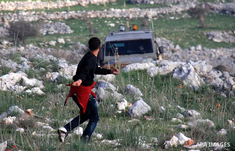 Palestinian protestors hurl stones at Israeli troops in the West Bank village of Iraq Borin near Nablus, on 05 March 2011. Two Palestinians were wounded after Israeli troops raided the village to stop clashes between Pal...