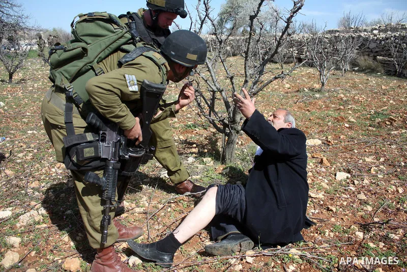 Israeli soldiers throw a stun grenade and fire tear gas towards Palestinian ,Israelian and International protesters during a demonstration against the demolishing of farm land to be used in the construction of Jewish set...