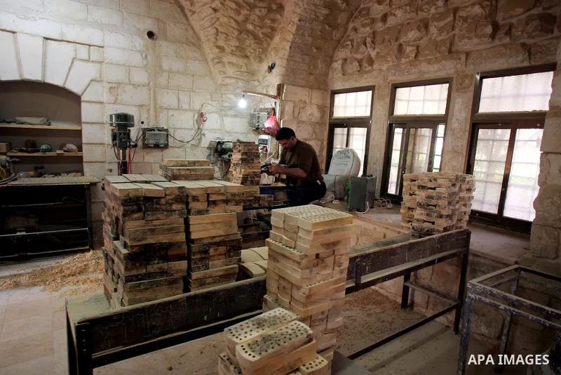 Palestinian blind men work in making brooms at a workshop in the Old City of Jerusalem on March 5,2011. The workshop is owned and managed by the Arab Blind Association, which was founded by blind Palestinians in 1932, an...