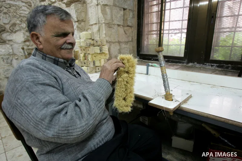 Palestinian blind men work in making brooms at a workshop in the Old City of Jerusalem on March 5,2011. The workshop is owned and managed by the Arab Blind Association, which was founded by blind Palestinians in 1932, an...