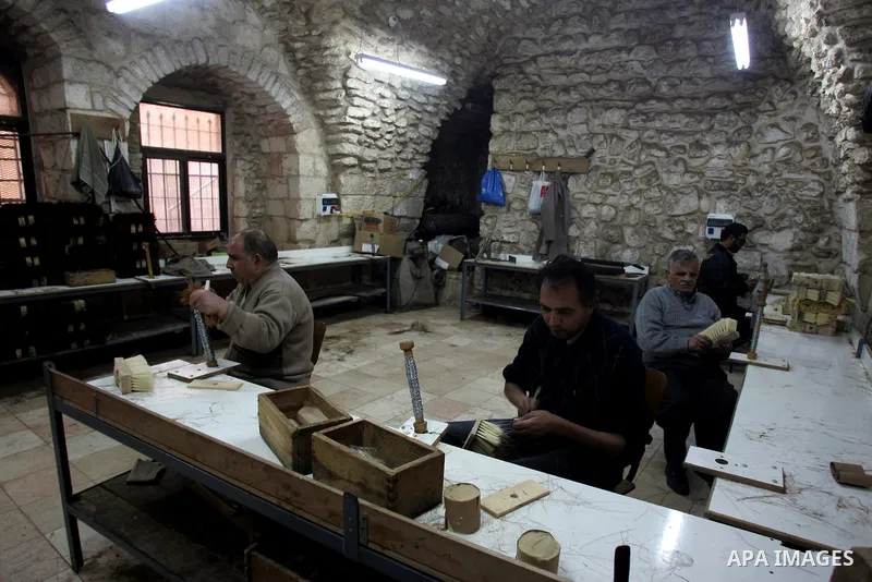 Palestinian blind men work in making brooms at a workshop in the Old City of Jerusalem on March 5,2011. The workshop is owned and managed by the Arab Blind Association, which was founded by blind Palestinians in 1932, an...