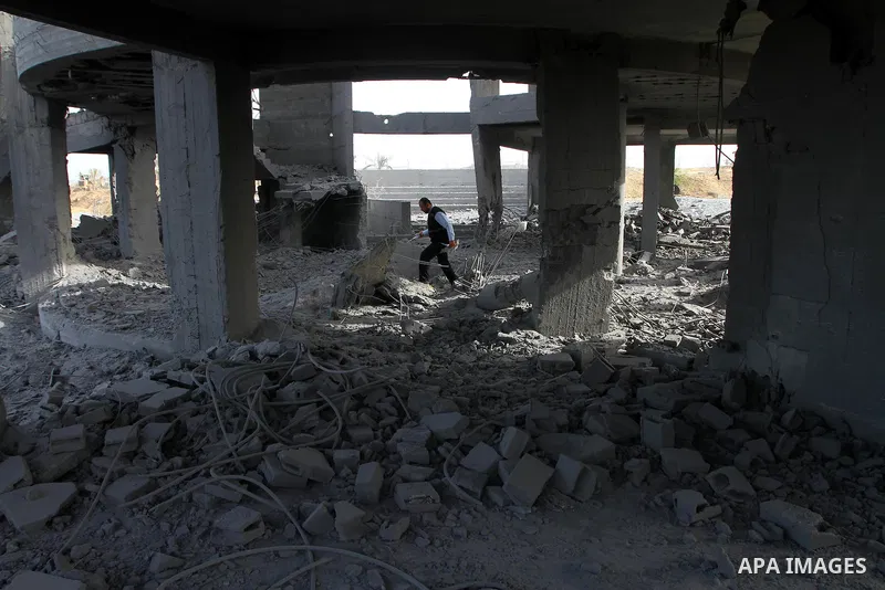 A Palestinian man inspects the damage to a building still under construction and belonging to the Islamic University, following an overnight Israeli air raid, south of Gaza City, on March 6, 2011. Photo by Ashraf Amra