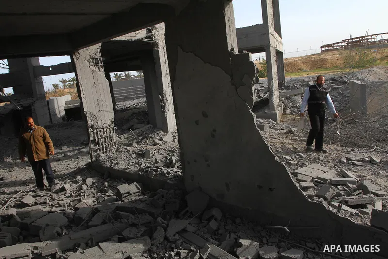 A Palestinian man inspects the damage to a building still under construction and belonging to the Islamic University, following an overnight Israeli air raid, south of Gaza City, on March 6, 2011. Photo by Ashraf Amra
