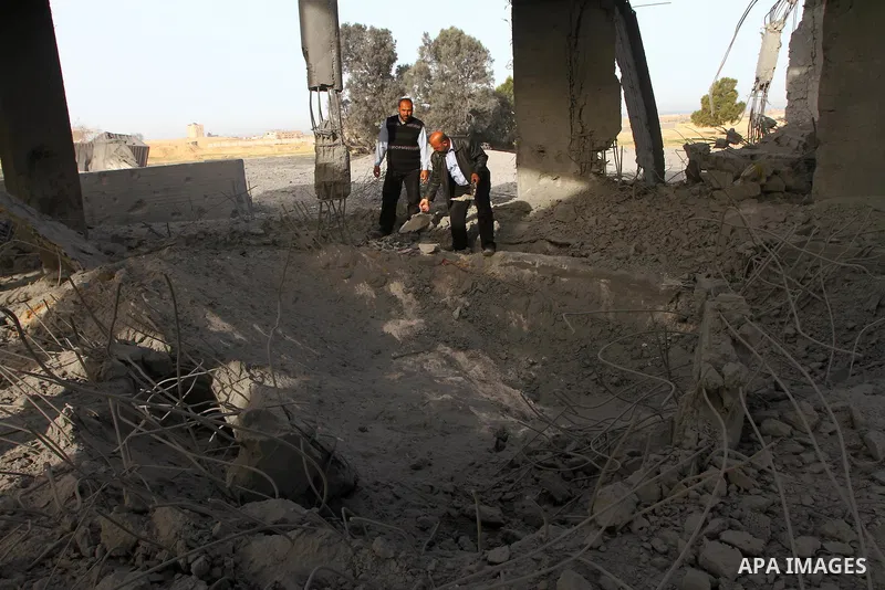 A Palestinian man inspects the damage to a building still under construction and belonging to the Islamic University, following an overnight Israeli air raid, south of Gaza City, on March 6, 2011. Photo by Ashraf Amra