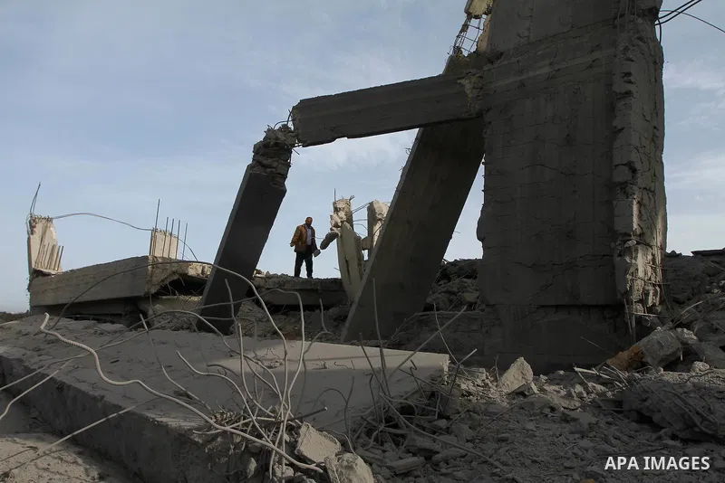 A Palestinian man inspects the damage to a building still under construction and belonging to the Islamic University, following an overnight Israeli air raid, south of Gaza City, on March 6, 2011. Photo by Ashraf Amra