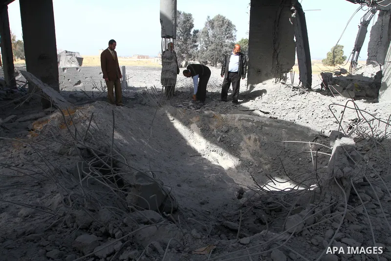 A Palestinian men inspects the damage to a building still under construction and belonging to the Islamic University, following an overnight Israeli air raid, south of Gaza City, on March 6, 2011. Photo by Ashraf Amra