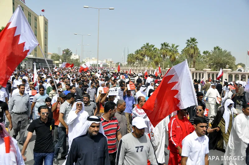 Bahraini anti-government protesters chant slogans Sunday, March 6, 2011, as thousands circle the Gudaibiya Palace compound in Manama, Bahrain, where the office of Prime Minister Khalifa bin Salman Al Khalifa is located....