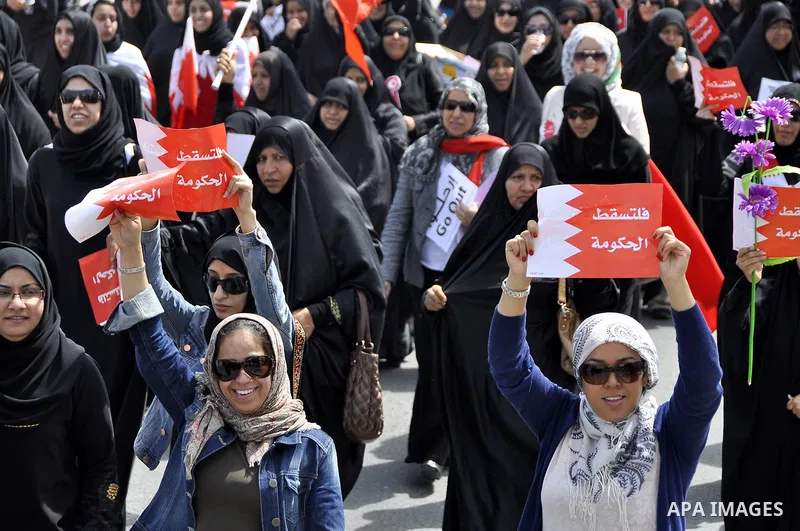 Bahraini anti-government protesters chant slogans Sunday, March 6, 2011, as thousands circle the Gudaibiya Palace compound in Manama, Bahrain, where the office of Prime Minister Khalifa bin Salman Al Khalifa is located....