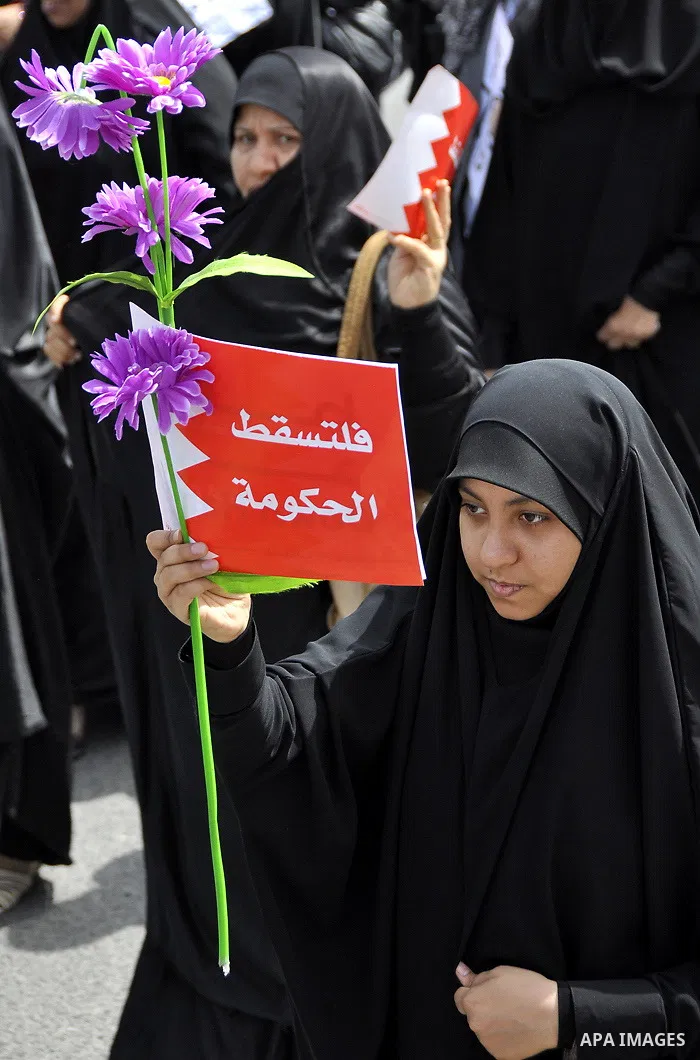 Bahraini anti-government protesters chant slogans Sunday, March 6, 2011, as thousands circle the Gudaibiya Palace compound in Manama, Bahrain, where the office of Prime Minister Khalifa bin Salman Al Khalifa is located....