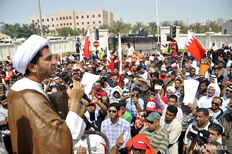 Bahraini anti-government protesters chant slogans Sunday, March 6, 2011, as thousands circle the Gudaibiya Palace compound in Manama, Bahrain, where the office of Prime Minister Khalifa bin Salman Al Khalifa is located....