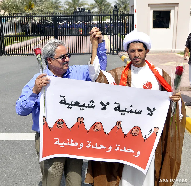 Bahraini anti-government protesters chant slogans Sunday, March 6, 2011, as thousands circle the Gudaibiya Palace compound in Manama, Bahrain, where the office of Prime Minister Khalifa bin Salman Al Khalifa is located....