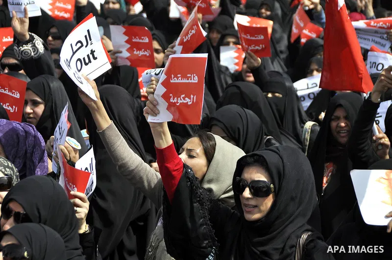 Bahraini anti-government protesters chant slogans Sunday, March 6, 2011, as thousands circle the Gudaibiya Palace compound in Manama, Bahrain, where the office of Prime Minister Khalifa bin Salman Al Khalifa is located....