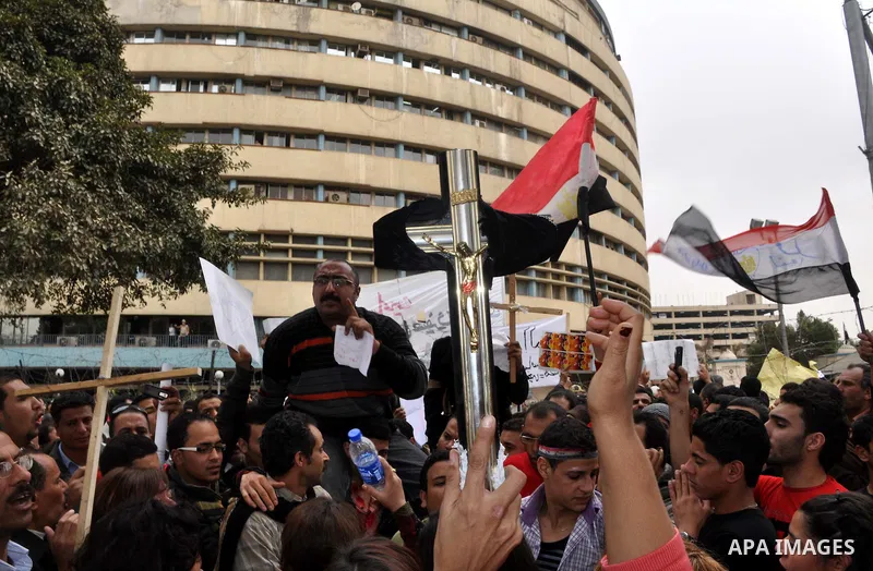 Egyptian christian protesters take part in a demonstration after burning a church in Hilwan, in front of the state television building headquarters in Cairo, Egypt, Sunday, March 6, 2011. Three weeks after President Hosn...