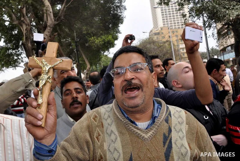Egyptian christian protesters take part in a demonstration after burning a church in Hilwan, in front of the state television building headquarters in Cairo, Egypt, Sunday, March 6, 2011. Three weeks after President Hosn...