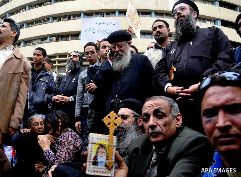 Egyptian christian protesters take part in a demonstration after burning a church in Hilwan, in front of the state television building headquarters in Cairo, Egypt, Sunday, March 6, 2011. Three weeks after President Hosn...