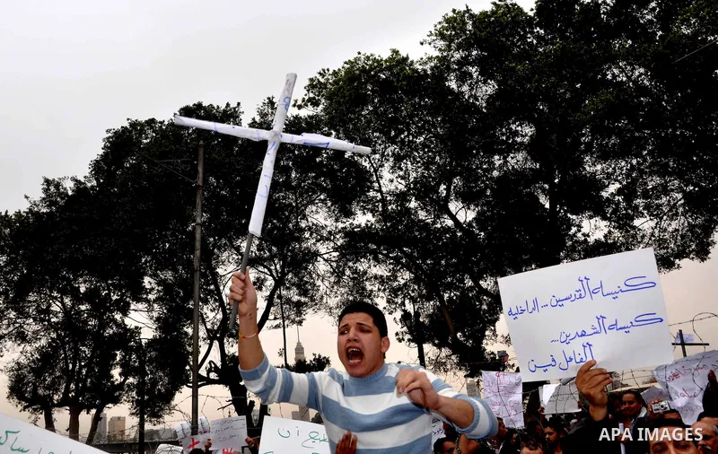 Egyptian christian protesters take part in a demonstration after burning a church in Hilwan, in front of the state television building headquarters in Cairo, Egypt, Sunday, March 6, 2011. Three weeks after President Hosn...