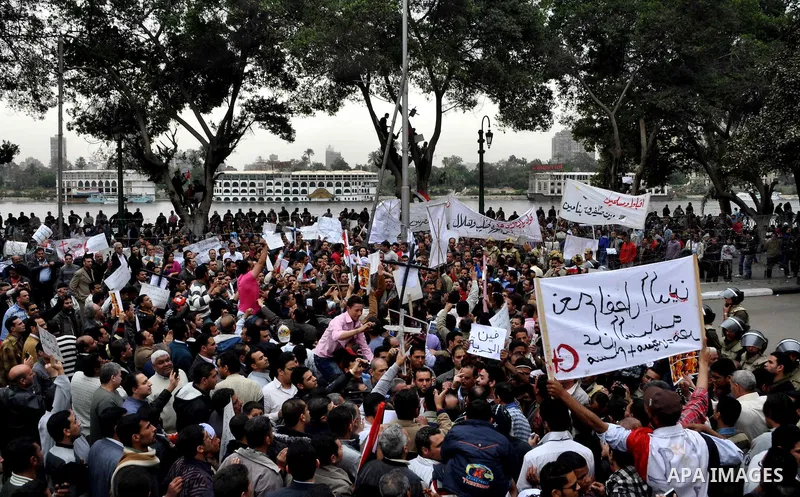 Egyptian christian protesters take part in a demonstration after burning a church in Hilwan, in front of the state television building headquarters in Cairo, Egypt, Sunday, March 6, 2011. Three weeks after President Hosn...