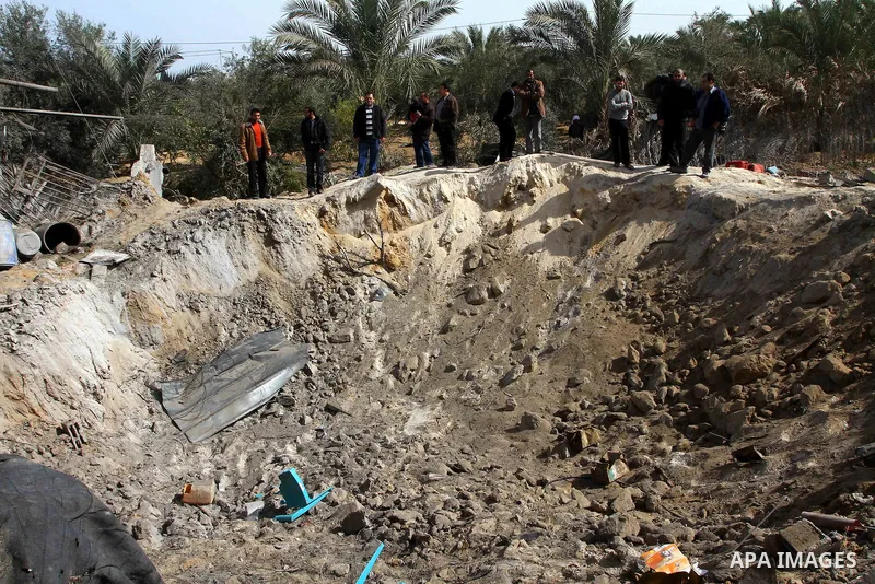 Palestinians inspect the damage following an Israeli airstrike in Deir al-Balah refugee camp, southern Gaza Strip, Sunday, March 6, 2011. Photo by Ashraf Amra
