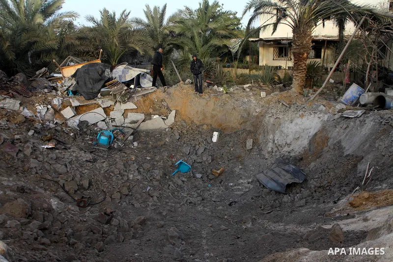 Palestinians inspect the damage following an Israeli airstrike in Deir al-Balah refugee camp, southern Gaza Strip, Sunday, March 6, 2011. Photo by Ashraf Amra