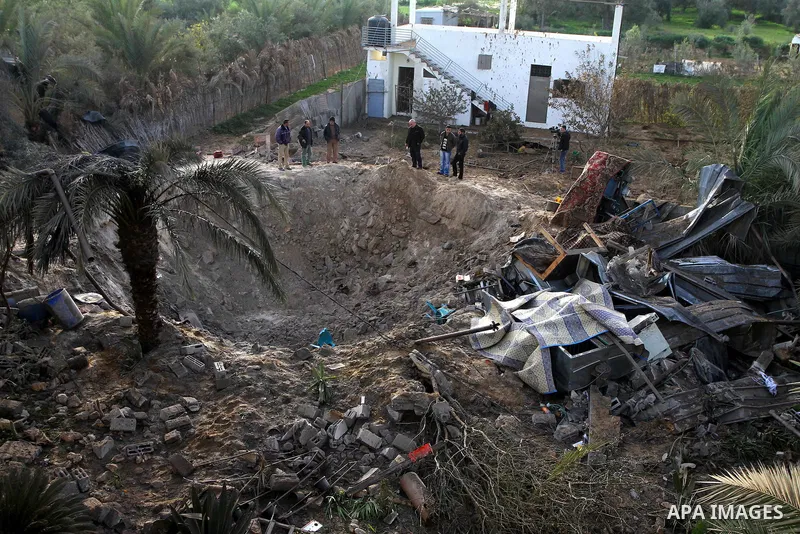 Palestinians inspect the damage following an Israeli airstrike in Deir al-Balah refugee camp, southern Gaza Strip, Sunday, March 6, 2011. Photo by Ashraf Amra