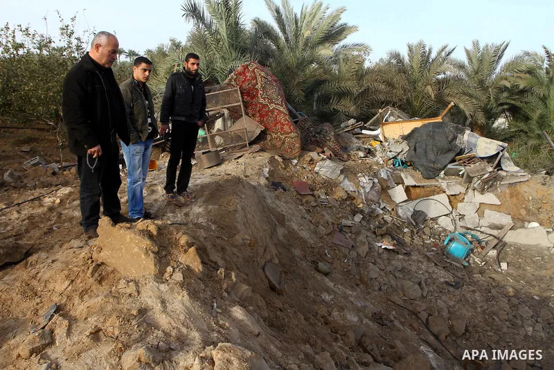 Palestinians inspect the damage following an Israeli airstrike in Deir al-Balah refugee camp, southern Gaza Strip, Sunday, March 6, 2011. Photo by Ashraf Amra