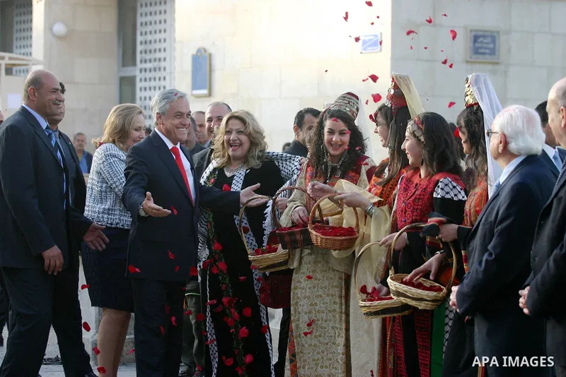 Chilean President Sebastian Pinera and his wife Cecilia Morel are greeted by Palestinian during their arrival at the Church of the Nativity, the site revered as the birthplace of Jesus, in the West Bank town of Bethlehem...