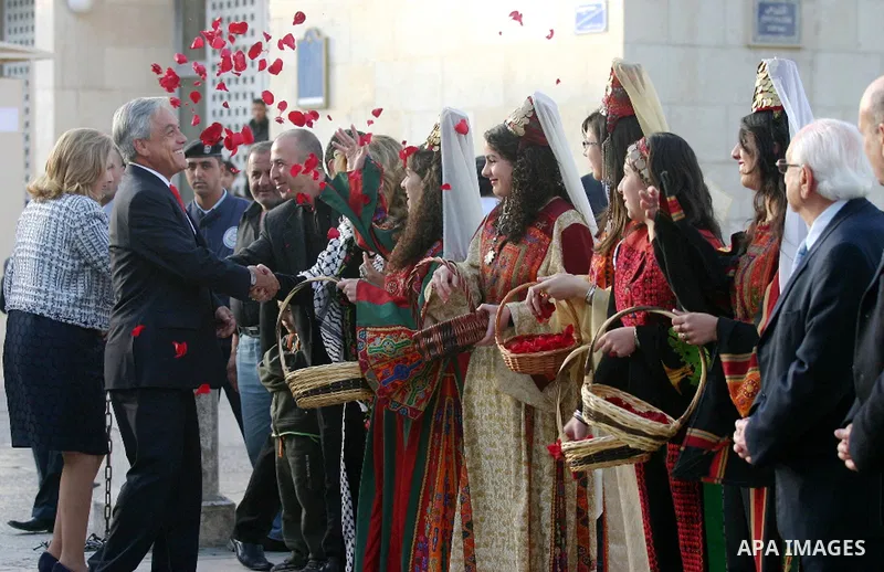 Chilean President Sebastian Pinera and his wife Cecilia Morel are greeted by Palestinian during their arrival at the Church of the Nativity, the site revered as the birthplace of Jesus, in the West Bank town of Bethlehem...
