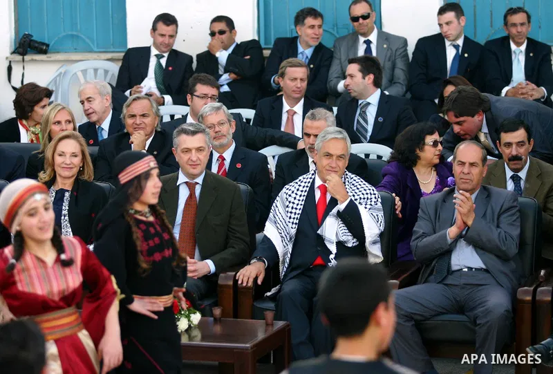 Chilean President Sebastian Pinera and his wife Cecilia Morel are greeted by Palestinian during their arrival at the Church of the Nativity, the site revered as the birthplace of Jesus, in the West Bank town of Bethlehem...