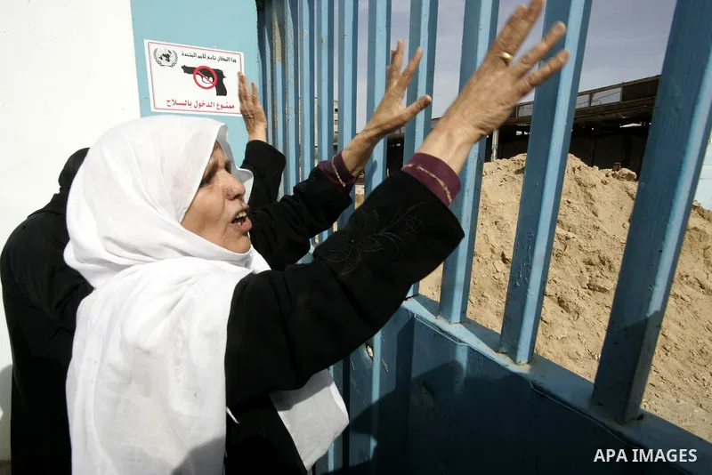Palestinians protest outside the UNRWA headquarters in the southern Gaza Strip Rafah refugee camp on March 6, 2011, calling for implementation of the United Nations decision to construct the houses which were destroyed d...