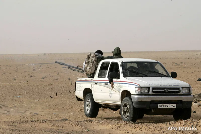 Rebel fighters return fire during shelling by soldiers loyal to Libyan leader Muammar Gaddafi in a battle near Ras Lanuf, March 4, 2011. Heavily armed rebels clashed with forces loyal to Gaddafi on Friday on the outskirt...