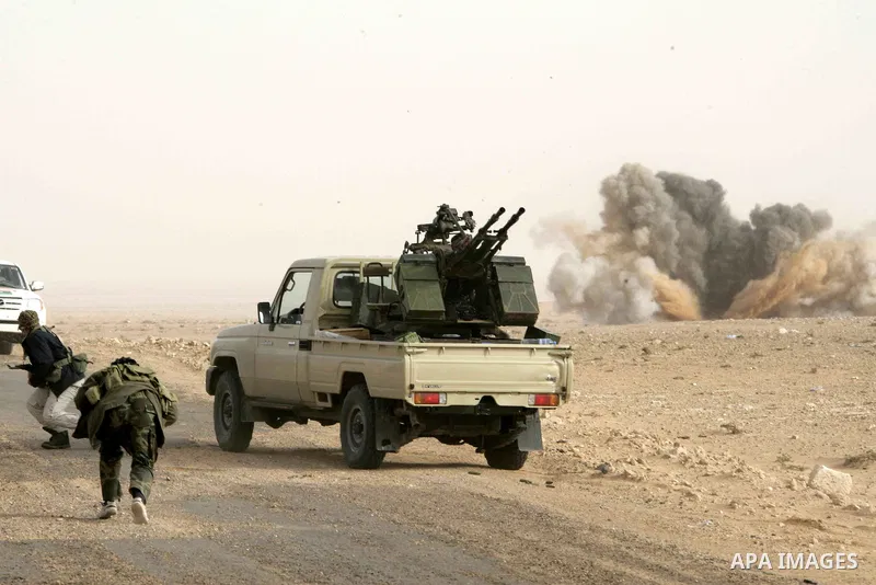 Rebel fighters take cover from shelling by soldiers loyal to Libyan leader Muammar Gaddafi during a battle near Ras Lanuf, March 4, 2011. Heavily armed rebels clashed with forces loyal to Gaddafi on Friday on the outskir...