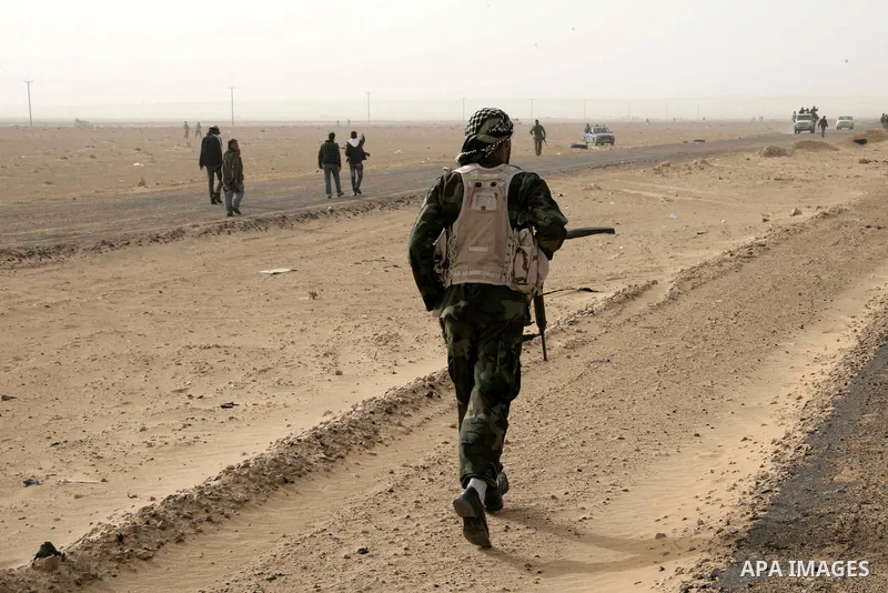 Rebel fighters return fire during shelling by soldiers loyal to Libyan leader Muammar Gaddafi in a battle near Ras Lanuf, March 4, 2011. Heavily armed rebels clashed with forces loyal to Gaddafi on Friday on the outskirt...