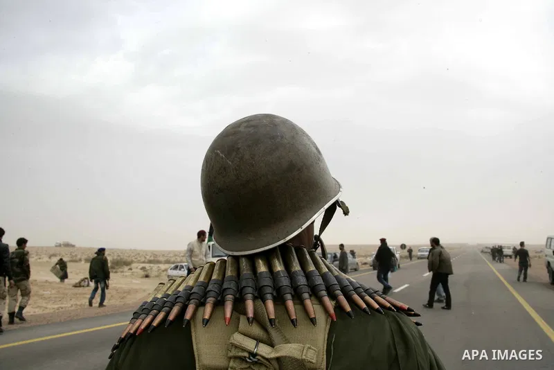Rebel fighters return fire during shelling by soldiers loyal to Libyan leader Muammar Gaddafi in a battle near Ras Lanuf, March 4, 2011. Heavily armed rebels clashed with forces loyal to Gaddafi on Friday on the outskirt...