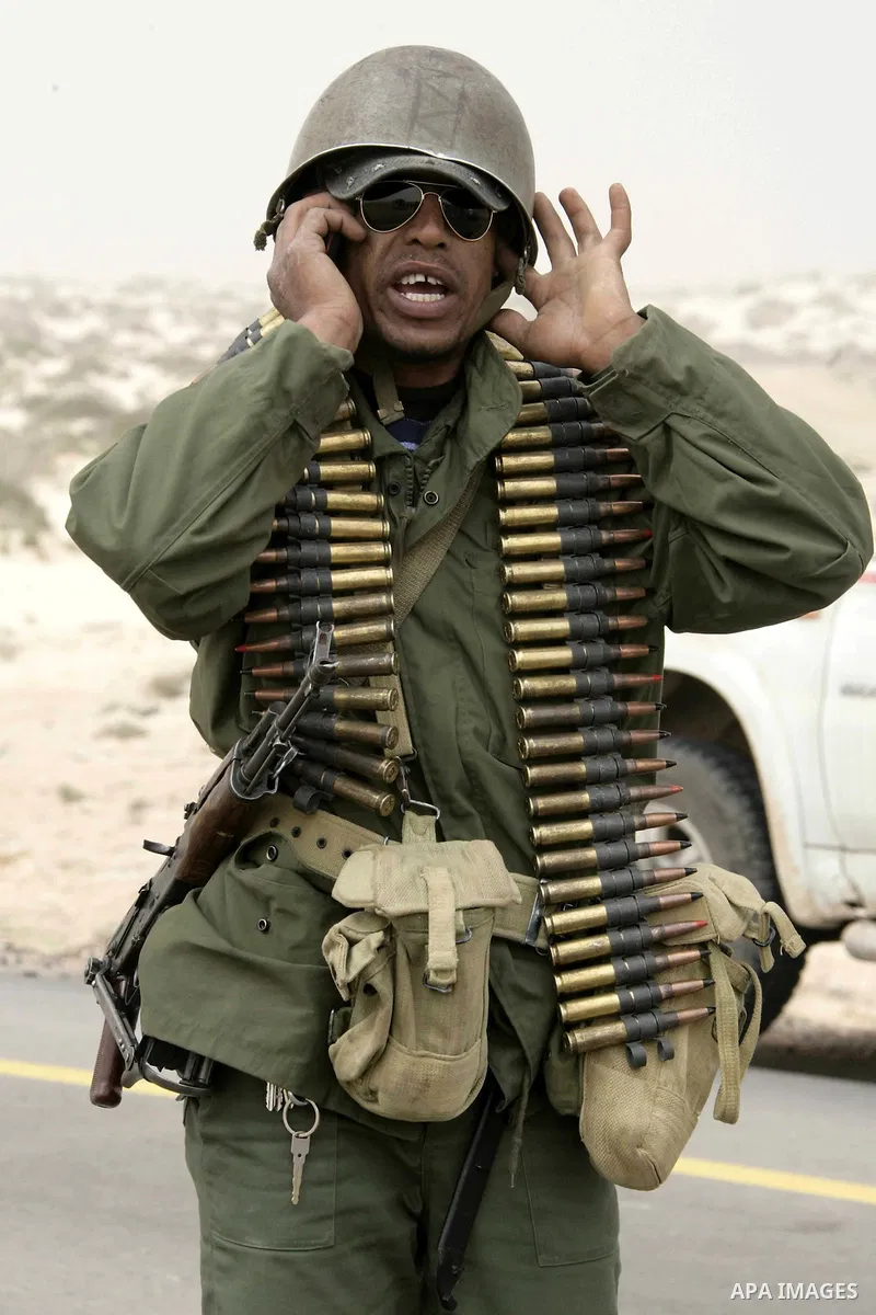 Rebel fighters return fire during shelling by soldiers loyal to Libyan leader Muammar Gaddafi in a battle near Ras Lanuf, March 4, 2011. Heavily armed rebels clashed with forces loyal to Gaddafi on Friday on the outskirt...