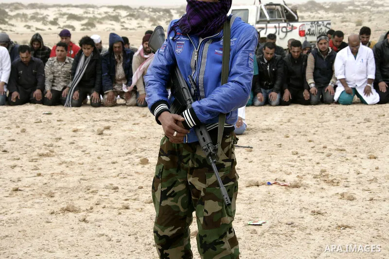 Rebel fighters return fire during shelling by soldiers loyal to Libyan leader Muammar Gaddafi in a battle near Ras Lanuf, March 4, 2011. Heavily armed rebels clashed with forces loyal to Gaddafi on Friday on the outskirt...