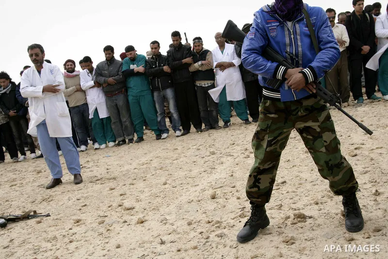 Rebel fighters return fire during shelling by soldiers loyal to Libyan leader Muammar Gaddafi in a battle near Ras Lanuf, March 4, 2011. Heavily armed rebels clashed with forces loyal to Gaddafi on Friday on the outskirt...