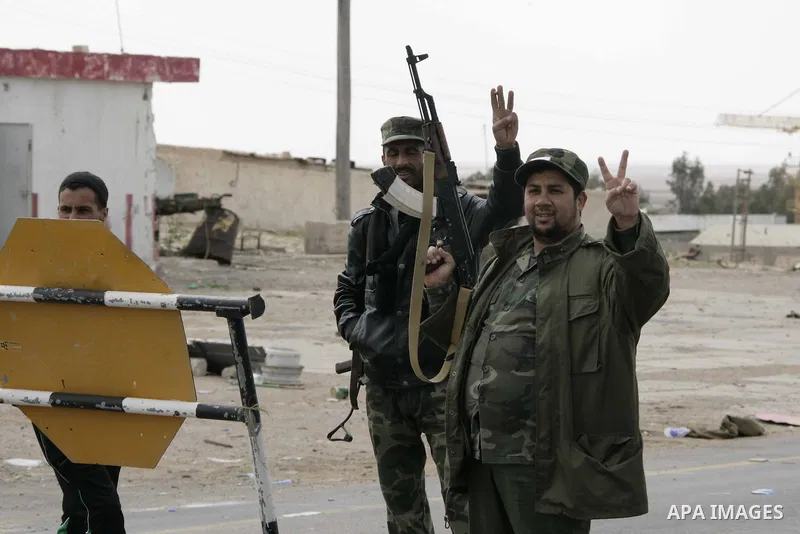 Rebel fighters return fire during shelling by soldiers loyal to Libyan leader Muammar Gaddafi in a battle near Ras Lanuf, March 4, 2011. Heavily armed rebels clashed with forces loyal to Gaddafi on Friday on the outskirt...