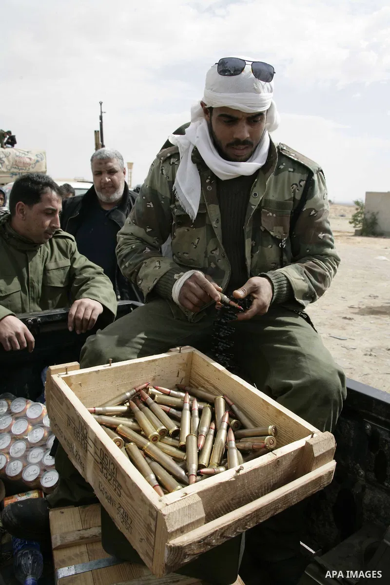 Rebel fighters return fire during shelling by soldiers loyal to Libyan leader Muammar Gaddafi in a battle near Ras Lanuf, March 4, 2011. Heavily armed rebels clashed with forces loyal to Gaddafi on Friday on the outskirt...