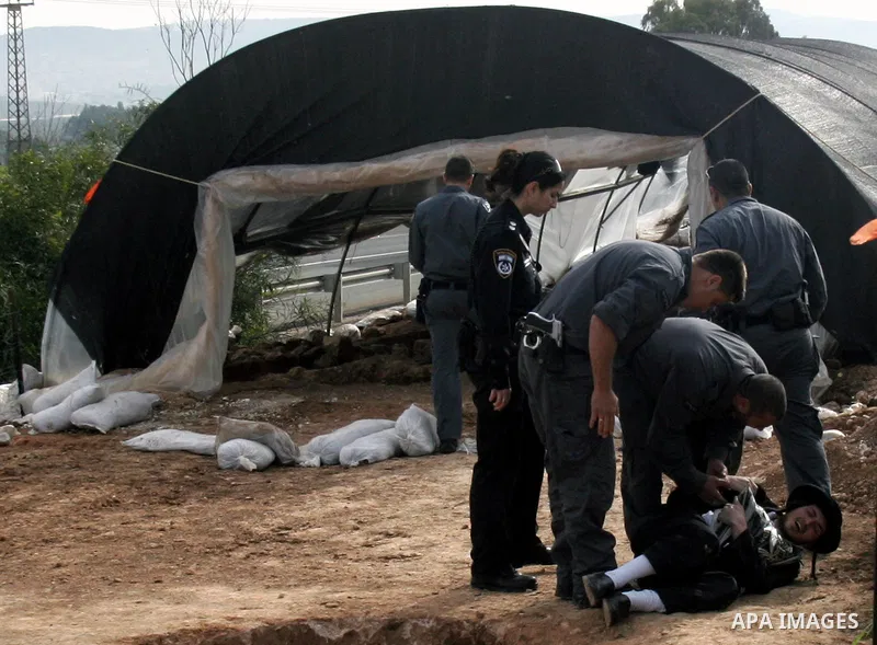 Israeli policeman arresting an ultra Orthodox during a protest against dig tombs in Haifa, on march 6, 2011. Photo by Mahfouz Abu Turk