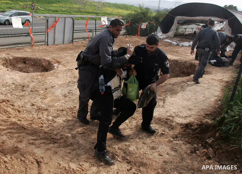 Israeli policeman arresting an ultra Orthodox during a protest against dig tombs in Haifa, on march 6, 2011. Photo by Mahfouz Abu Turk