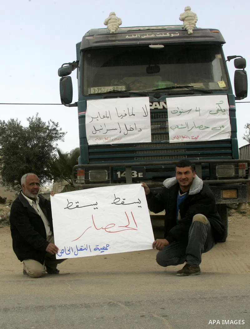 Palestinians stop with their lorries near the crossing of the Israeli crossing Kerem Shalom during a protest against the Israeli decision to close the Karni crossing, in the southern Gaza Strip on March 07, 2011. The own...