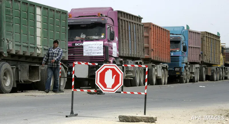 Palestinians stop with their lorries near the crossing of the Israeli crossing Kerem Shalom during a protest against the Israeli decision to close the Karni crossing, in the southern Gaza Strip on March 07, 2011. The own...