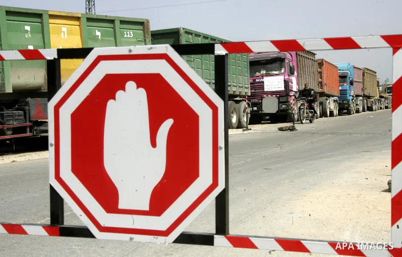 Palestinians stop with their lorries near the crossing of the Israeli crossing Kerem Shalom during a protest against the Israeli decision to close the Karni crossing, in the southern Gaza Strip on March 07, 2011. The own...