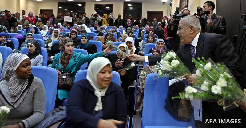 Palestinian Prime Minister, Salam Fayyad receives a note from the Palestinian workers general union about the rights of women workers in the West Bank city of Ramallah on March7, 2011. Photo by Mustafa Abu Dayeh