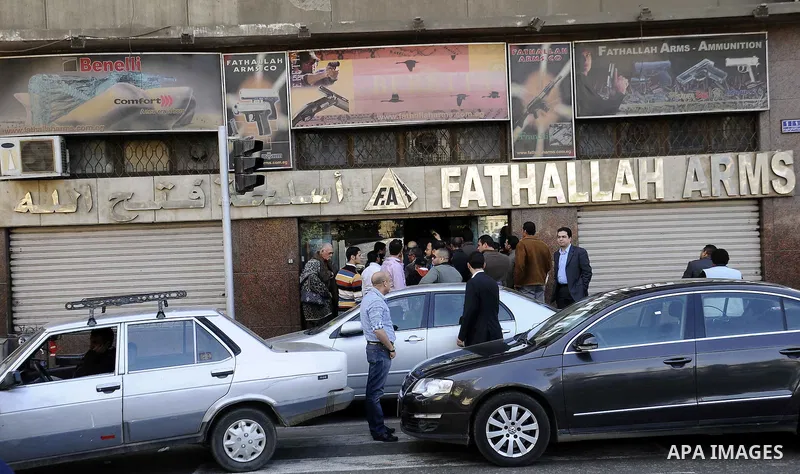 Egyptians gather in front of a shop for weapons in Cairo, Egypt, March 7, 2011. Photo by Ahmed Asad